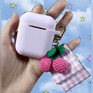 AirPods purple case with knit cheery and accessories